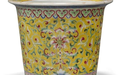 A Chinese porcelain famille rose jardiniere, late 19th century, painted to the body with continuous flowering lotus on a yellow ground, apocryphal iron red Qianlong mark to base, 14cm high Provenance: From the collection of an important Greek...