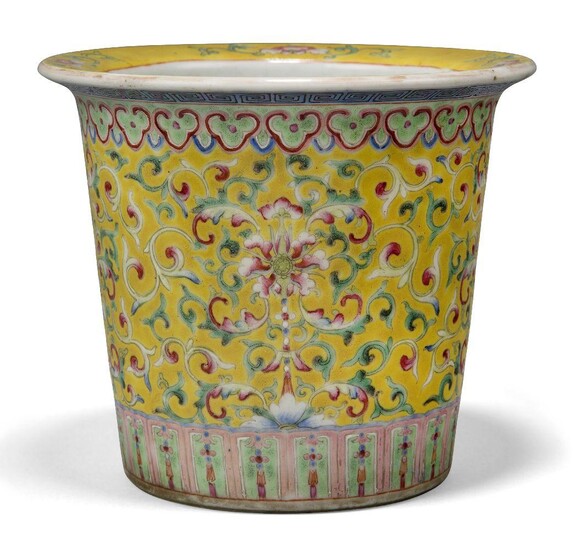A Chinese porcelain famille rose jardiniere, late 19th century, painted to the body with continuous flowering lotus on a yellow ground, apocryphal iron red Qianlong mark to base, 14cm high Provenance: From the collection of an important Greek...
