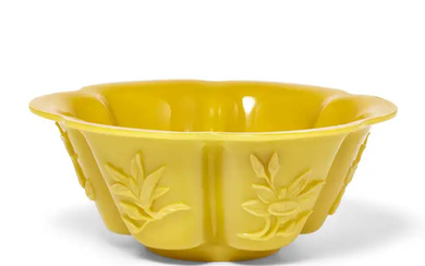 A Chinese yellow 'Peking' glass foliate bowl, 20th century, each face carved...