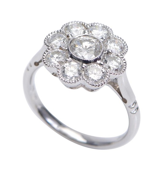 A DIAMOND RING-Of floral cluster design, centred with a round brilliant cut diamond weighing 0.50cts, within a surround of eight fur...