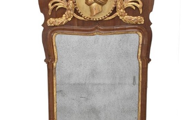 A Danish Rococo walnut framed mirror with giltwood carvings. Mid 18th century....