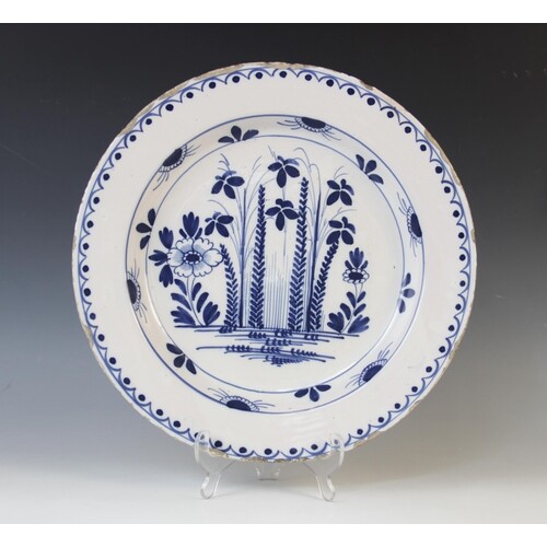 A Delft ware charger, 18th century, the tin glazed earthenwa...