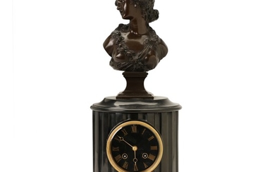 A French figural patinated bronze and black marble table clock, movement stamped 'Roblin a Paris'. Late 19th century. H. 44 cm. W. 24 cm.