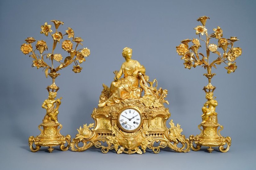 A French gilt bronze three piece clock garniture...