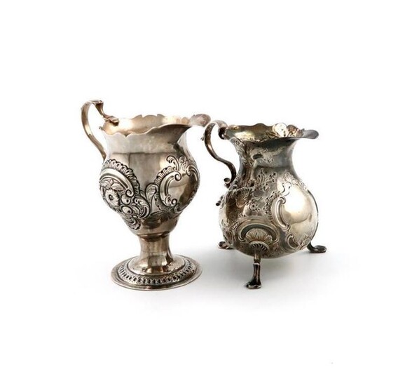 A George II silver cream jug, by Phillip Goddard, London 1743, baluster form, leaf capped scroll handle, embossed foliate and scroll decoration, on four pad feet, plus a George III silver cream jug, by Nathaniel Appleton and Anne Smith, London 1774...