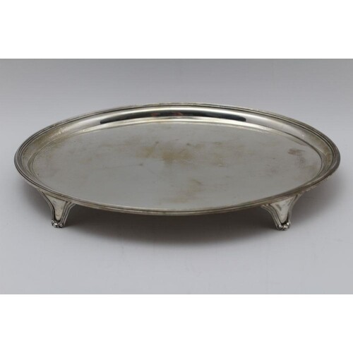 A George III oval silver salver, with reeded rim raised on f...