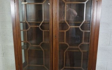 A George III style mahogany china cabinet on stand, 20th century reproduction, with two astragal