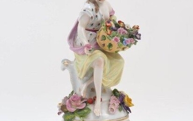A Meissen style vase cover, 19th century, the finial modelled as a female figure resting against a cartouche and holding a basket of flowers, with floral encrustations around her feet, the cover with pierced design and decorated with flowers and...