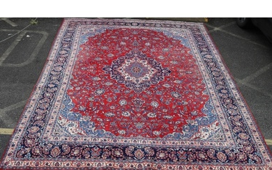 A Persian Sarouk carpet on cream, red and blue ground with c...