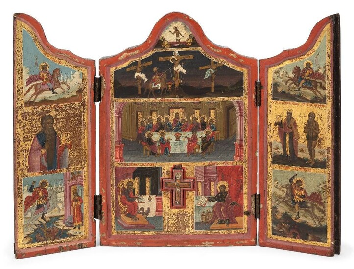 A Russian travelling triptych icon, early 19th century, the central panel depicting the Last Supper, the Crucifixion and set with a crucifix flanked by Luke the Evangelist and John the Evangelist, the hinged doors with further saints, including St...