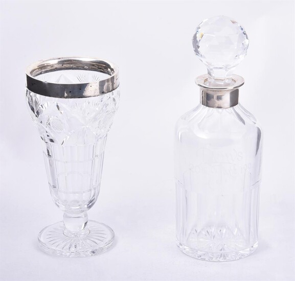 A SILVER MOUNTED CUT GLASS DECANTER, K. M. SILVER