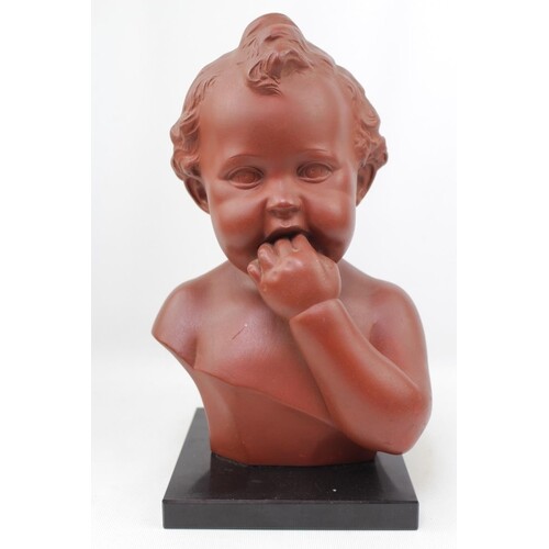 A Terracotta bust of a young child with impressed mark to re...