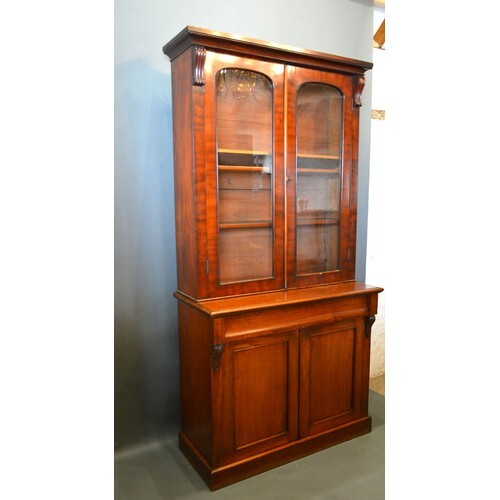 A Victorian Mahogany Bookcase, the moulded cornice above two...