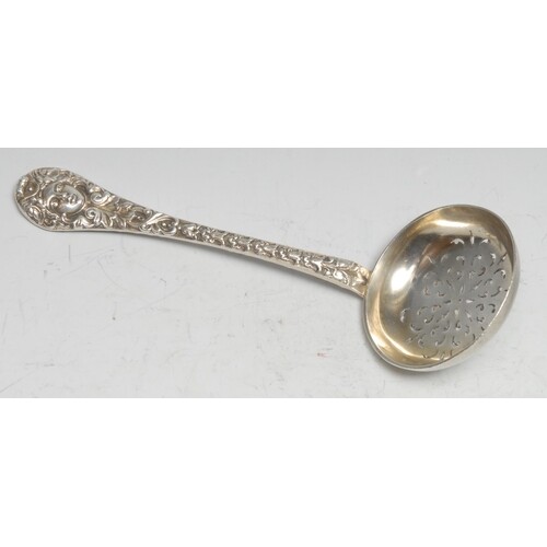 A Victorian cast silver sifter spoon, the leafy stem centred...