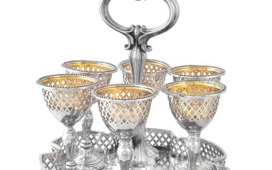 A Victorian silver shaped circular egg cup stand and six egg cups by Henry Wilkinson & Co.