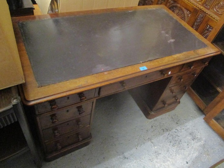 A Victorian walnut twin pedestal desk having a leather toppe...