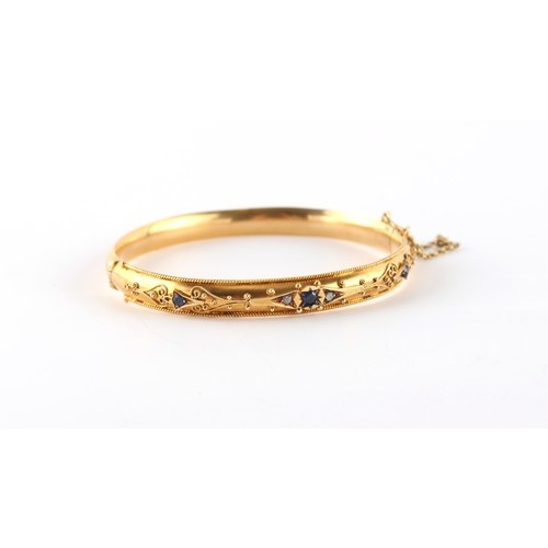 A Victorian yellow gold (tests 15ct) hinged bangle set with ...