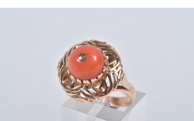 A YELLOW METAL CORAL RING, set with a raised coral cabochon ...