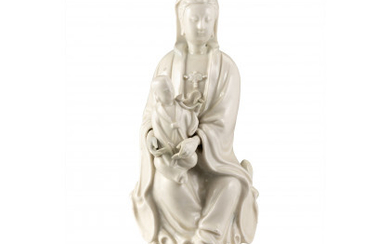 A blanc de Chine Guanyin with child (restorations) China, early 19th century (h. 28 cm.)