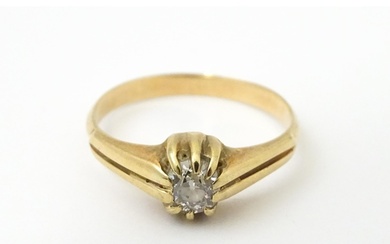 A gold ring set with diamond solitaire. Ring size approx. M
