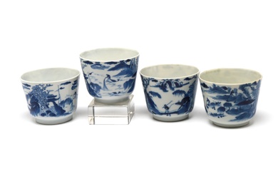 A group of blue and white porcelain teacups, each painted with landscape design