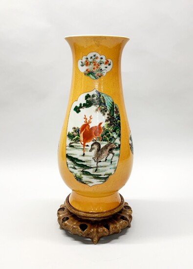 A large Chinese hand painted vase decorated with dragons and fish on a carved wooden stand, vase H. 42cm.