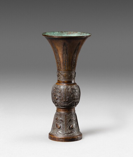 A large bronze archaistic beaker vase, gu 17th-18th century | 十七至十八世紀 青銅仿古紋花觚