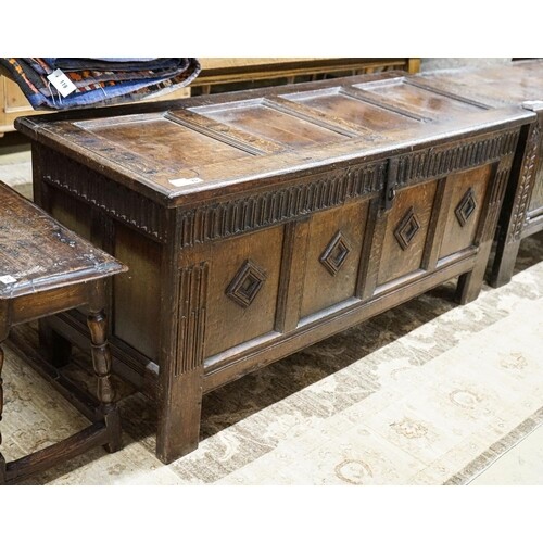 A late 17th century oak coffer, with four panel top and carv...