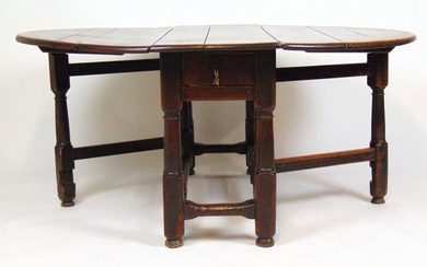 A late 17th/early 18th century oak gate leg dining table,...
