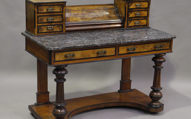 A late Victorian walnut and ebonized marble-topped dressing table, fitted with an arrangement of dra