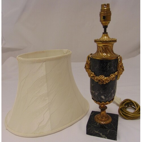 A marble and gilt metal table lamp, oval with floral brass s...