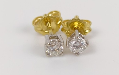 A pair of 18ct white and yellow gold diamond stud earrings