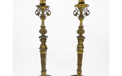 A pair of 19thC Continental cast brass tall candlesticks wit...