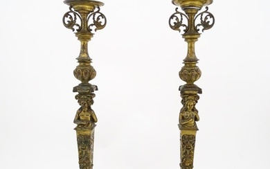 A pair of 19thC Continental cast brass tall candlesticks with figural, lions mask and foliate