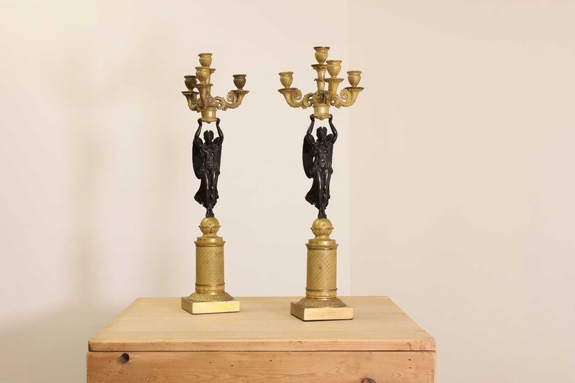 A pair of French Empire ormolu and bronze candelabra