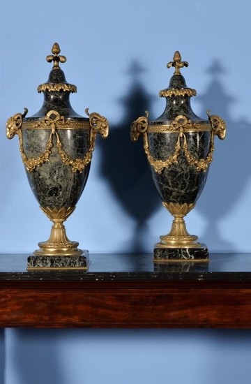 A pair of French green serpentine marble and gilt metal mounted urns in Louis XVI style