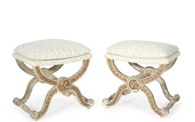 A pair of Louis XVI style cream-painted and parcel-gilt...
