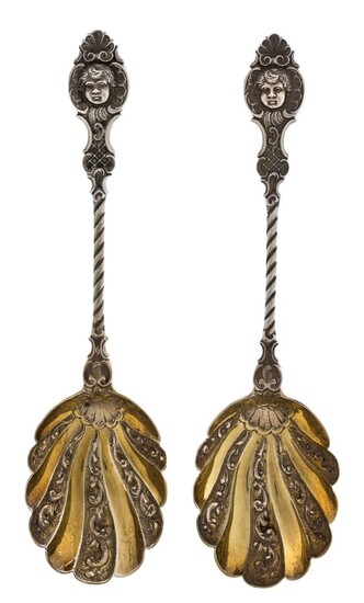 A pair of Victorian silver serving spoons, London, 1895, Goldsmiths & Silversmiths Co., designed with scalloped gilt bowls to twisted stems and mask terminals, 21.2cm long, total weight approx. 5.2oz (pr)