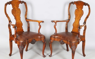 A pair of early 20th century Queen Anne style walnut vase back elbow chairs with brown leather drop