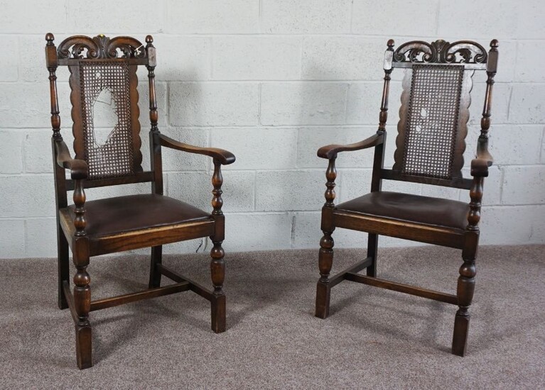 A pair of oak framed Carolean style armchairs, early 20th Century, with fretwork carved crest rails