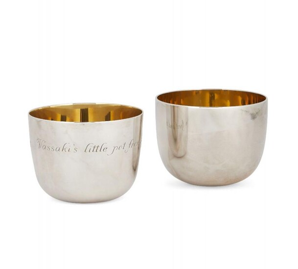 A pair of silver tumblers with gilt...