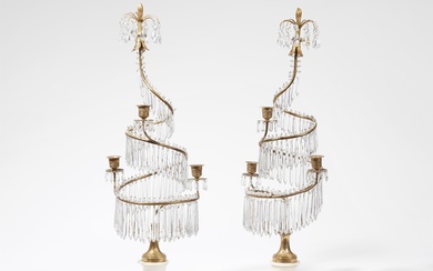 A pair of three-flame bronze candelabra