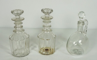 A pair of triple ring neck decanters and stoppers, 19th century, with paneled bodies, and a