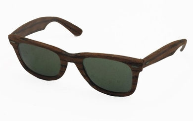 A pair of vintage Ray-Ban Bausch & Lomb Wayfarer sunglasses, wood finish frames with metal hinges, stamped 'B&L 5022' above right-side lens, with leather case