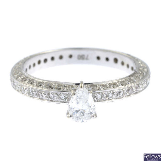 A pear-shape diamond single-stone ring, with pave-set diamond band.