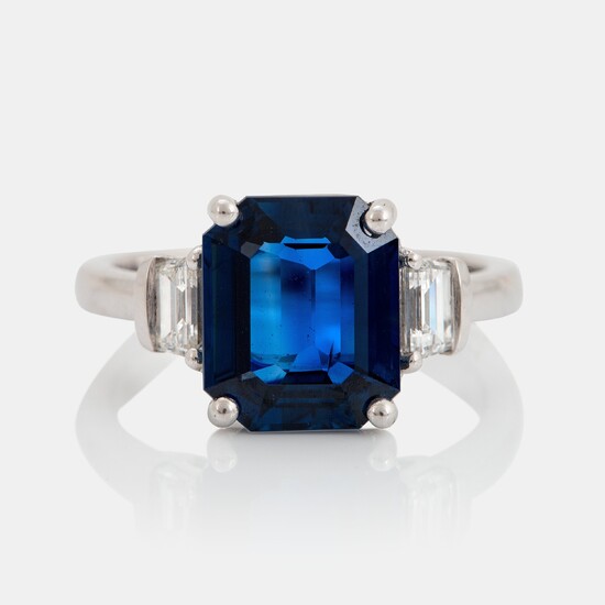 A platinum ring set with a step-cut sapphire weight 4.58 cts