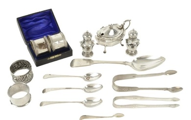 A selection of silver to include various spoons, sugar tongs, napkin rings & condiments.