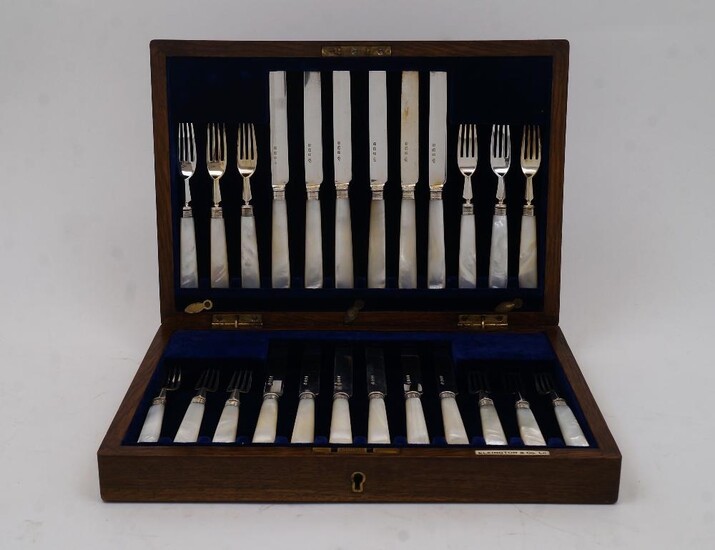 A set of mother of pearl-handled silver fruit eaters, Birmingham, 1921, Elkington & Co Ltd, comprising twelve knives and twelve forks, in fitted oak case