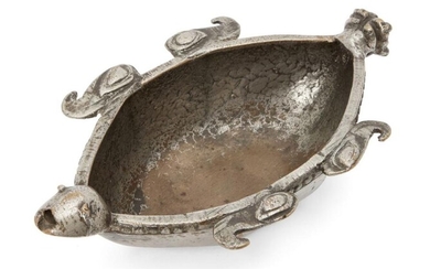 A silvered brass bowl in the form...