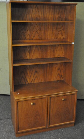 A vintage G-Plan display cabinet, separating into two parts, the top comprising three shelves